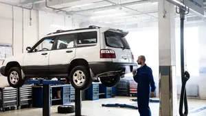 A car up on the ramp in a workshop.